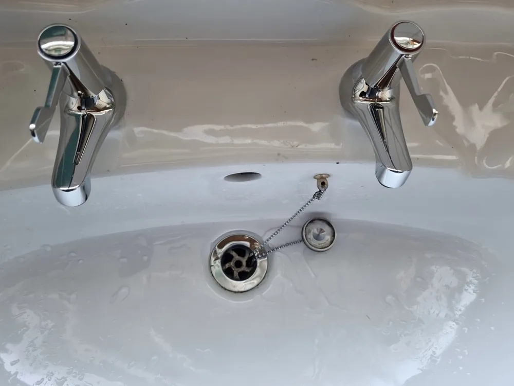 New modern chrome basin taps after replacement in Coventry